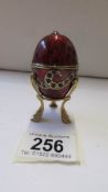 A Faberge' style egg trinket box on stand.