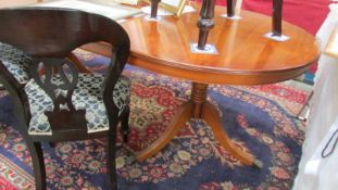 An oval mahogany double pedestal extending dining table on lion paw feet, COLLECT ONLY.