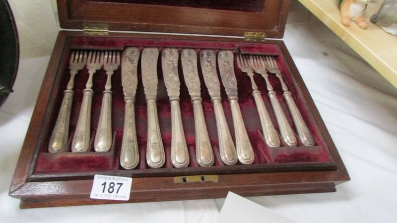 A walnut cased set of 12 fish knives and forks.