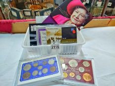 A selection of UK coin sets including Queen Mother Memorial Crown etc.