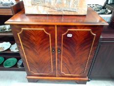 A dark wood stained 2 door cupboard with inner draw. 79cm x 47cm x height 88cm. COLLECT ONLY.