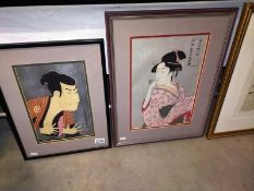 Two framed and glazed signed Japanese pictures of a man and a woman. COLLECT ONLY.