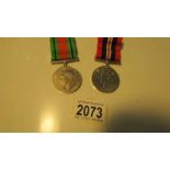 A Defence medal with ribbon, a 1939-45 war medal with ribbon, Mr J K Steel, 353/22673.