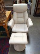 A leather swivel chair with stool.