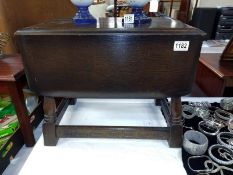 A small drop leaf swivel top dark oak tea table. 51cm x 32cm (68cm) x Height 41cm.