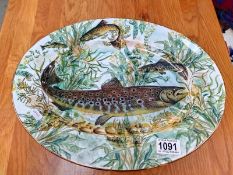 An oval platter decorated with pike by House of Stewart, 40 cm x 31 cm.