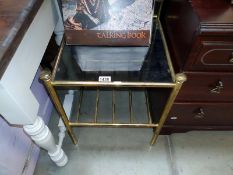 A brass framed coffee table with smoke glass. Top 42cm x 42, shelf height 49cm. COLLECT ONLY.