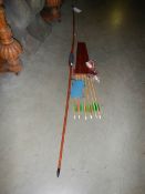 An English solid bamboo long bow, 30lb at 28" draw, with arrows, case, finger tab and arm protector.