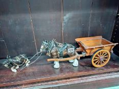 A pottery horse and cart and a smaller horse.