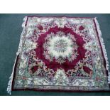 A middle Eastern style floral patterned rug. Length 250 cm x 240cm. COLLECT ONLY.