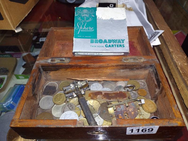 An old wooden box of old mainly foreign coins