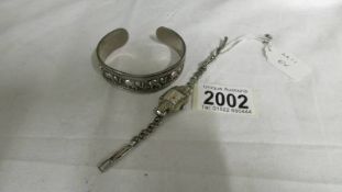 A silver elephant motif bangle and a ladies marcasite wrist watch.