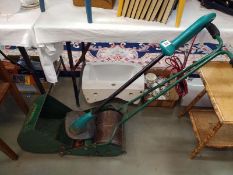 A Webb roller dust cylinder lawnmower and a Bosch Art strimmer. COLLECT ONLY.