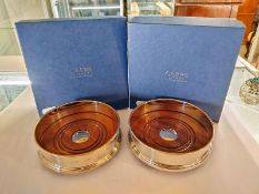 A boxed pair of Carrs hallmarked silver wine coasters