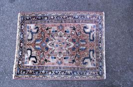 A middle Eastern style patterned rug. Length 105cm x 80cm. COLLECT ONLY.