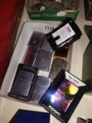 A quantity of Zippo lighters.