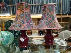 A pair of red pottery table lamps with shades, COLLECT ONLY.