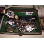 A tin box and contents including watches and parts.