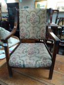 A 1930's oak arm chair with tapestry seat. COLLECT ONLY.