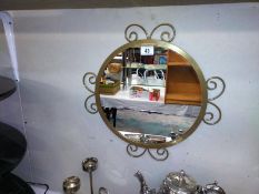 A round ornate mirror. COLLECT ONLY.