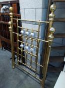 A decorated brass and porcelain single bed head and footer. COLLECT ONLY.