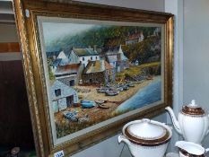 A large gilt framed oil on canvas of a fishing village, signed Keith Ward. 93 cm x 67cm.