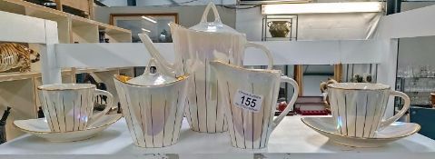 An art deco coffee pot, milk jug and sugar bowl plus 2 cups and saucers
