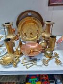 A selection of brassware including shell cases, carriage hub nut, etc