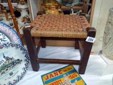 An Oak stool with string top seat, COLLECT ONLY.