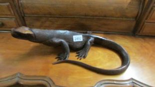 A carved wood lizard, 43 cm long.