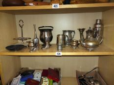 A shelf of silver/ pewter plated items