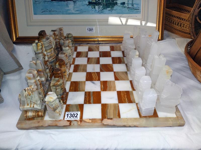 A polished stone chess set. COLLECT ONLY.