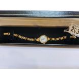 A vintage gold watch in working order with gold strap, 14.5gms