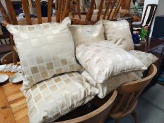 Seven matching gold coloured cushions.