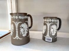 Two 19th Century brown Jasperware jugs, no markings. Height 17.5cm and 15cm