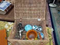 A basket of miscellaneous, including silver plated candlesticks, art nouveau pottery planter