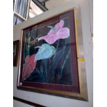 A large silver framed floral print