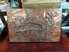 A worked Copper wall plaque of a Tudor house signed indistinct 79. 55cm x 36cm.