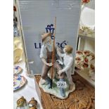 A boxed Lladro Fishing Lesson withdrawn 1/1/2003 Width 18cm x 15cm x height 30cm. Sculptor