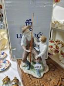 A boxed Lladro Fishing Lesson withdrawn 1/1/2003 Width 18cm x 15cm x height 30cm. Sculptor