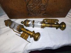 A pair of brass wall mounted candle lamps. Both A/F