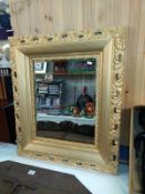 An ornate gilt framed bevel edge mirror. COLLECT ONLY.