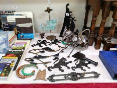A quantity of metal ware including novelty dog bottle holder, rampant lions & a fish wall bracket