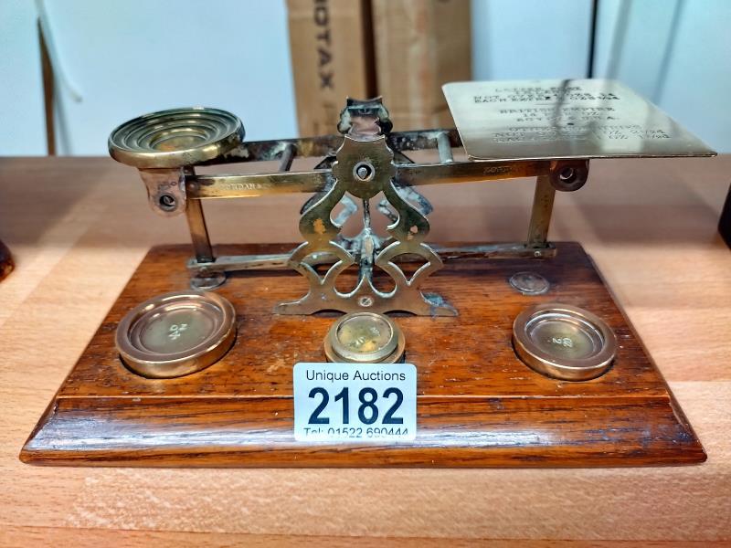 Victorian/Edwardian brass postal scales by S. Morden & co London. On a Oak base with weights