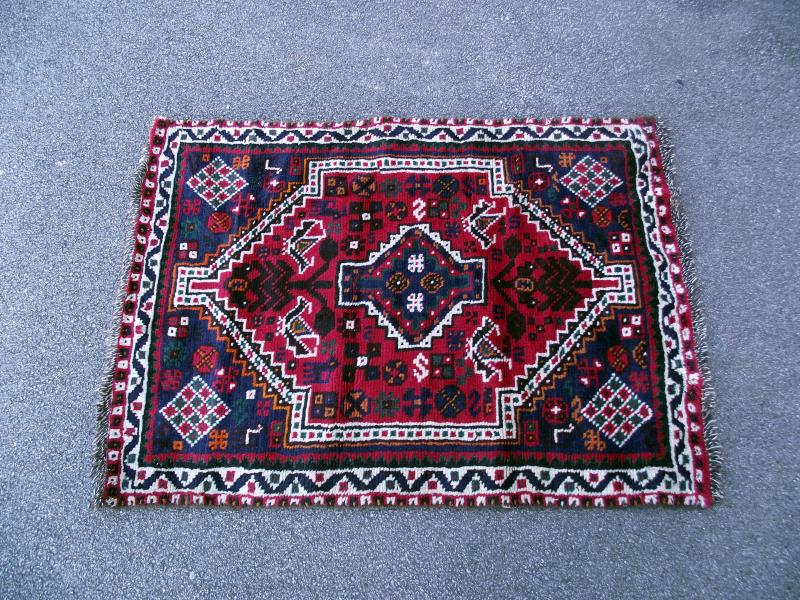 A small red/blue Persian style rug. Length 140cm x 97cm. COLLECT ONLY.