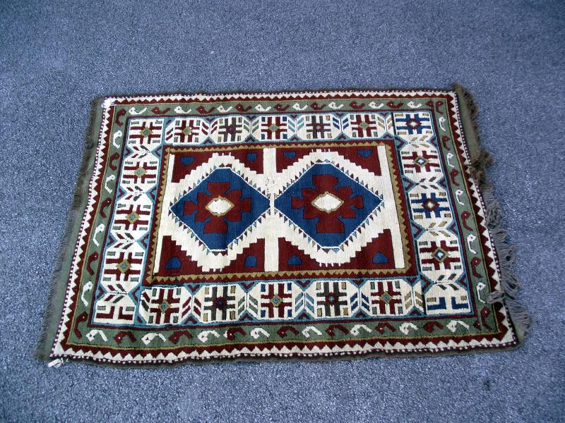 A multi coloured Aztec/Block pattern rug. Length 190cm x 130cm. COLLECT ONLY.