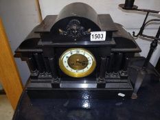 A Victorian black slate mantle clock.