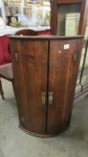 A Victorian oak bow front corner cupboard with double doors, COLLECT ONLY.