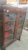 An Edwardian oak display cabinet with leaded glass doors, 95 x 25 x 133 cm high, COLLECT ONLY.