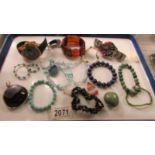 A mixed lot of stone pendants, bracelets etc and two wrist watches.